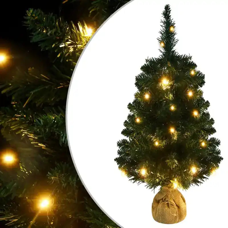 Artificial Christmas tree with warm LED lights and burlap base.
