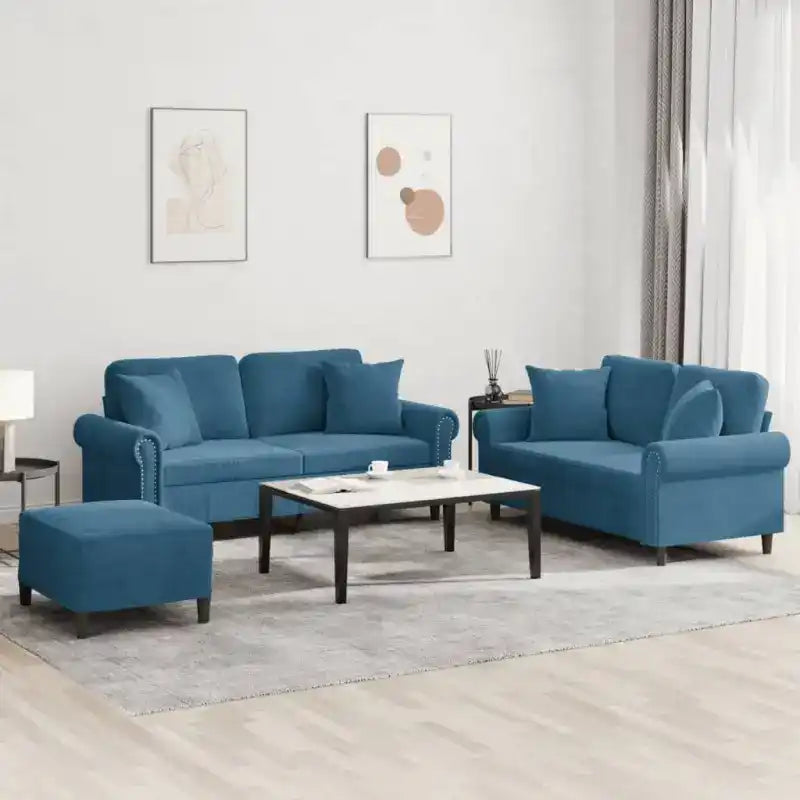 Blue upholstered living room set consisting of a sofa, loveseat and ottoman with a coffee table.