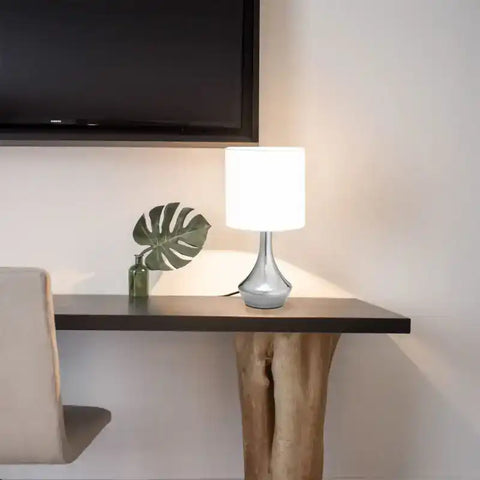 Modern table lamp with a gray base and white shade.