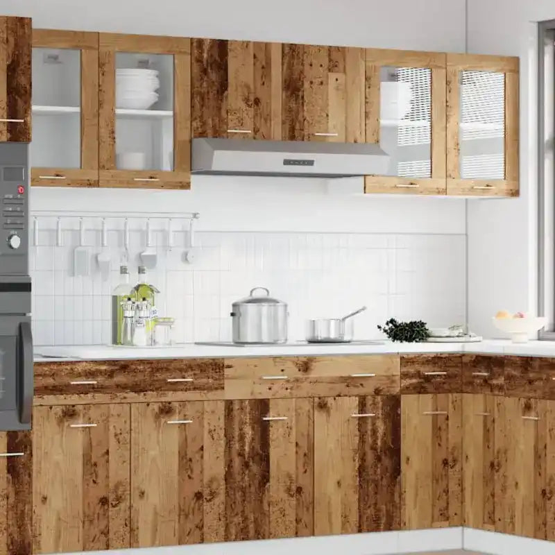 Rustic wooden kitchen cabinets with white countertops and stainless steel appliances.