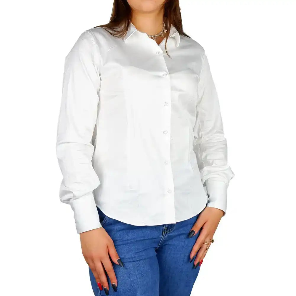 White button-up dress shirt paired with blue jeans.
